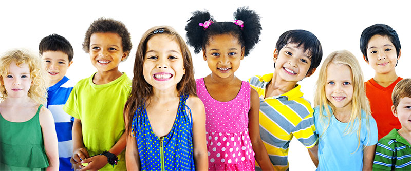 The image shows a diverse group of children with various skin tones and hair colors, standing together smiling at the camera.